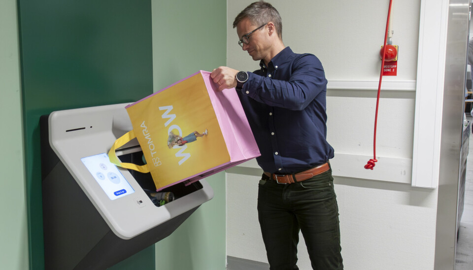 Produktsjef Jonas Døvik demonstrerer hvordan du kan tømme flaskene inn i panteautomaten, og få pantelappen på mobilen når automaten er ferdig. 📸: Kurt Lekanger